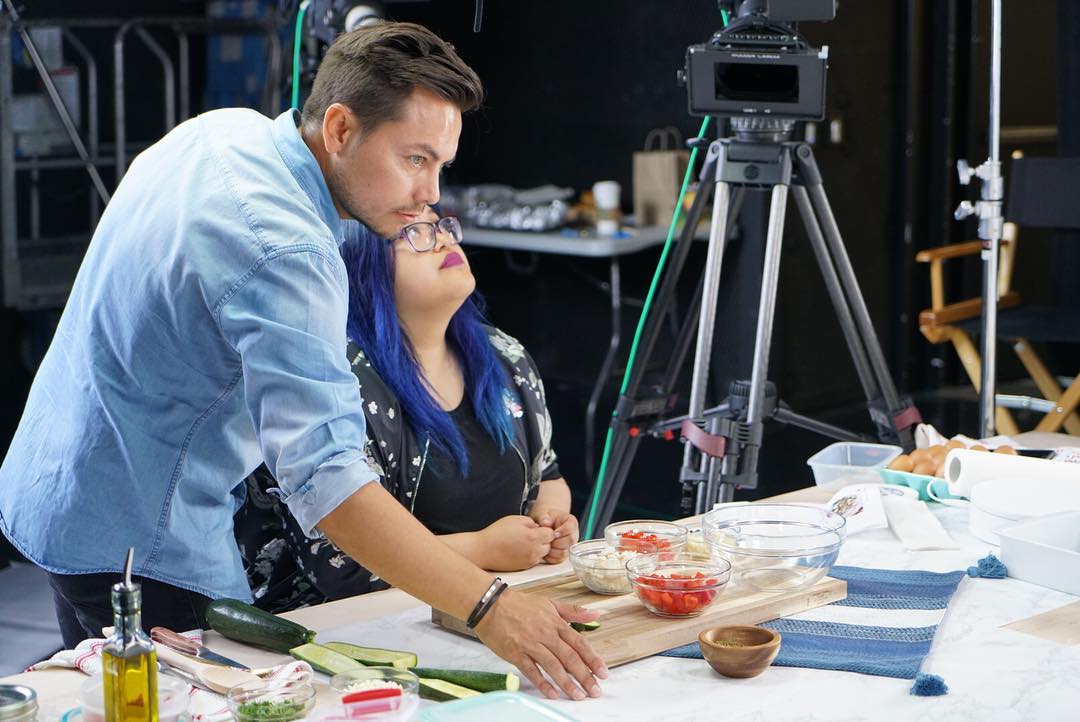 Director and talent on cooking show set