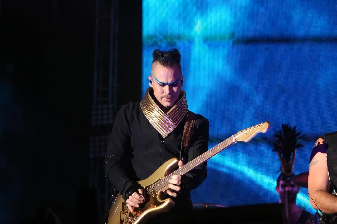 Guitarist performing under stage lights