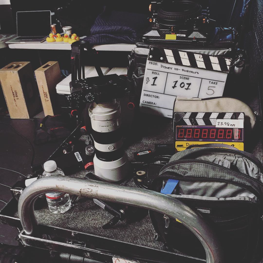 Film set with clapperboard and gear